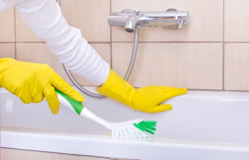 Deep cleaning a bathroom during a move out service in Utton