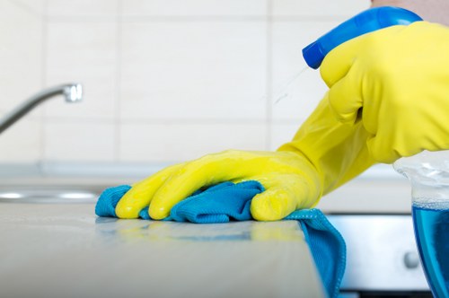 Professional cleaners maintaining reception and desk areas in Utton