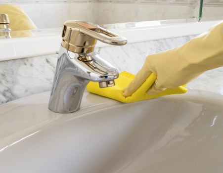 Local Utton short-let cleaner sanitising a bathroom during a turnover clean